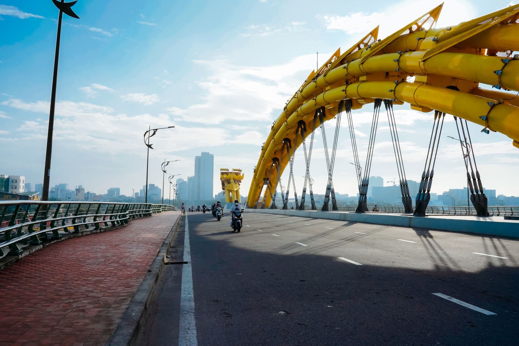 Scooters crossing the yellow Dragon Bridge in Da Nang